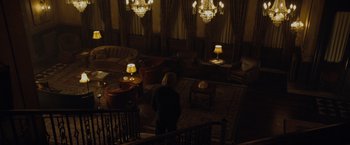 Movie still from “The Curious Case of Benjamin Button” (2008), directed by David Fincher – A woman standing on a staircase in a dark room; Extreme Wide shot, High angle