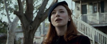 Movie still from “The Curious Case of Benjamin Button” (2008), directed by David Fincher – A woman with red hair wearing a black hat; Close Up shot, Low angle