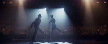 Movie still from “The Curious Case of Benjamin Button” (2008), directed by David Fincher – A couple of people that are dancing on a stage; Wide shot, Low angle