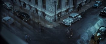 Movie still from “The Curious Case of Benjamin Button” (2008), directed by David Fincher – An aerial view of people walking down a street; Extreme Wide shot, High angle
