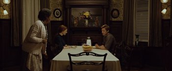 Movie still from “The Curious Case of Benjamin Button” (2008), directed by David Fincher – A man and a woman sitting at a dinner table; Wide shot, Over the shoulder angle