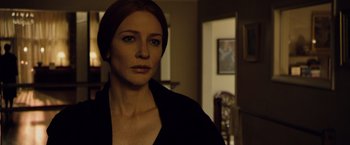 Movie still from “The Curious Case of Benjamin Button” (2008), directed by David Fincher – A person wearing a black shirt in a room; Close Up shot, Over the shoulder angle