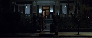 Movie still from “The Curious Case of Benjamin Button” (2008), directed by David Fincher – A man and a woman walking down the steps of a house; Wide shot, Low angle