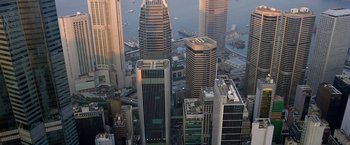 Movie still from “The Dark Knight” (2008), directed by Christopher Nolan – An aerial view of a large city with boats in the water; Extreme Wide shot, High angle