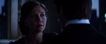 Movie still from “The Dark Knight” (2008), directed by Christopher Nolan – A man and a woman in a dark room looking at each other; Close Up shot, Over the shoulder angle