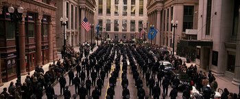 Movie still from “The Dark Knight” (2008), directed by Christopher Nolan – A large group of police officers are gathered in a courtyard; Extreme Wide shot, High angle