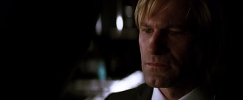 Movie still from “The Dark Knight” (2008), directed by Christopher Nolan – A person wearing a suit and tie; Close Up shot, Low angle