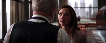 Movie still from “The Dark Knight” (2008), directed by Christopher Nolan – A man and a woman looking at one another; Close Up shot, Over the shoulder angle