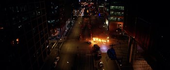 Movie still from “The Dark Knight” (2008), directed by Christopher Nolan – An aerial view of a city street at night; Extreme Wide shot, High angle
