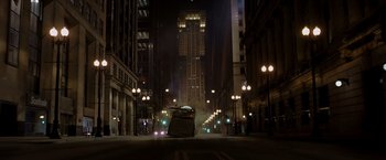 Movie still from “The Dark Knight” (2008), directed by Christopher Nolan – A car driving down a street at night; Extreme Wide shot, Low angle