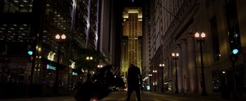 Movie still from “The Dark Knight” (2008), directed by Christopher Nolan – A man standing in the middle of a street at night; Extreme Wide shot, Low angle