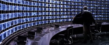 Movie still from “The Dark Knight” (2008), directed by Christopher Nolan – A room that has a bunch of pictures on the wall; Extreme Wide shot, High angle