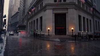 Movie still from “The Dark Knight Rises” (2012), directed by Christopher Nolan – A fire hydrant spewing water onto a city street; Extreme Wide shot, High angle