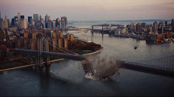 Movie still from “The Dark Knight Rises” (2012), directed by Christopher Nolan – An aerial view of a city with a bridge in the middle of it; Extreme Wide shot, High angle