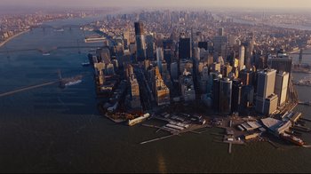 Movie still from “The Dark Knight Rises” (2012), directed by Christopher Nolan – An aerial view of a large city with a large body of water in front of it; Extreme Wide shot, High angle