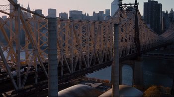 Movie still from “The Dark Knight Rises” (2012), directed by Christopher Nolan – A view of a bridge with a train on it's tracks; Extreme Wide shot, High angle