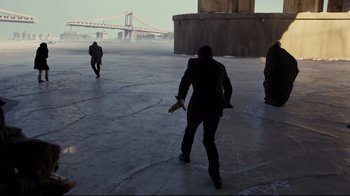 Movie still from “The Dark Knight Rises” (2012), directed by Christopher Nolan – A group of people standing on a concrete surface; Extreme Wide shot, High angle