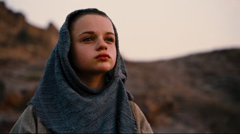 Movie still from “The Dark Knight Rises” (2012), directed by Christopher Nolan – A young girl wearing a blanket and a scarf; Close Up shot, Low angle