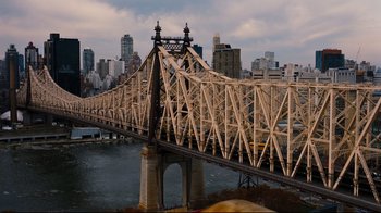 Movie still from “The Dark Knight Rises” (2012), directed by Christopher Nolan – A view of a bridge that is over a body of water; Extreme Wide shot, High angle