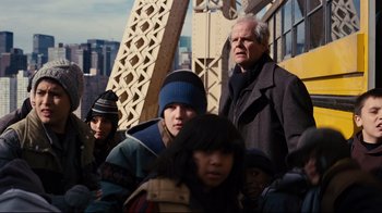 Movie still from “The Dark Knight Rises” (2012), directed by Christopher Nolan – A group of people standing next to each other on top of a bridge; Medium shot, Over the shoulder angle