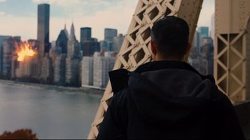 Movie still from “The Dark Knight Rises” (2012), directed by Christopher Nolan – A man looking out over a city from a bridge; Wide shot, Over the shoulder angle