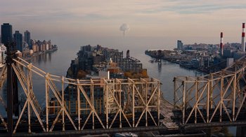 Movie still from “The Dark Knight Rises” (2012), directed by Christopher Nolan – An aerial view of a city with a large body of water in the background; Extreme Wide shot, High angle