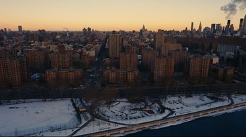 Movie still from “The Dark Knight Rises” (2012), directed by Christopher Nolan – An aerial view of a large city at sunset; Extreme Wide shot, High angle