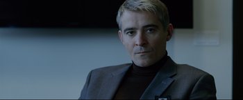 Movie still from “The Girl with the Dragon Tattoo” (2011), directed by David Fincher – A person wearing a suit; Close Up shot, Over the shoulder angle