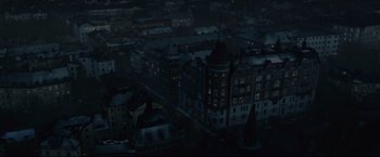 Movie still from “The Girl with the Dragon Tattoo” (2011), directed by David Fincher – An aerial view of a city at night with lights on buildings; Extreme Wide shot, High angle