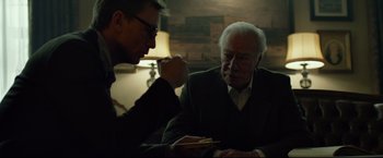 Movie still from “The Girl with the Dragon Tattoo” (2011), directed by David Fincher – Two men sitting at a table talking to each other; Medium shot, Over the shoulder angle