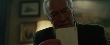 Movie still from “The Girl with the Dragon Tattoo” (2011), directed by David Fincher – An older man looking down at a piece of paper; Close Up shot, Over the shoulder angle