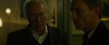 Movie still from “The Girl with the Dragon Tattoo” (2011), directed by David Fincher – A man standing next to another man in front of a door; Close Up shot, Low angle