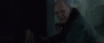Movie still from “The Girl with the Dragon Tattoo” (2011), directed by David Fincher – An older man in a dark room looking at the camera; Close Up shot, Over the shoulder angle