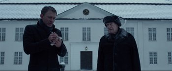 Movie still from “The Girl with the Dragon Tattoo” (2011), directed by David Fincher – Two men standing in front of a white building; Medium shot, Low angle