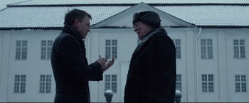 Movie still from “The Girl with the Dragon Tattoo” (2011), directed by David Fincher – Two men talking to each other outside of a house; Medium shot, Over the shoulder angle