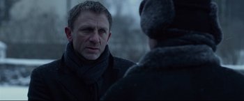 Movie still from “The Girl with the Dragon Tattoo” (2011), directed by David Fincher – A man wearing a scarf and a jacket talking to another man wearing a hat; Close Up shot, Over the shoulder angle
