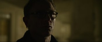 Movie still from “The Girl with the Dragon Tattoo” (2011), directed by David Fincher – A person wearing glasses; Close Up shot, Over the shoulder angle