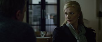 Movie still from “The Girl with the Dragon Tattoo” (2011), directed by David Fincher – A woman sitting in front of a mirror in a room; Close Up shot, Over the shoulder angle