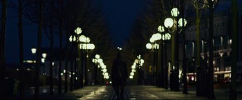Movie still from “The Girl with the Dragon Tattoo” (2011), directed by David Fincher – A person walking down a street at night; Extreme Wide shot, Low angle