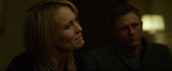 Movie still from “The Girl with the Dragon Tattoo” (2011), directed by David Fincher – A person looking up at something; Close Up shot, Over the shoulder angle