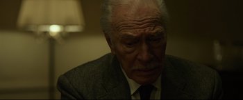 Movie still from “The Girl with the Dragon Tattoo” (2011), directed by David Fincher – An older man in a suit and tie looking sad; Close Up shot, Low angle