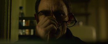 Movie still from “The Girl with the Dragon Tattoo” (2011), directed by David Fincher – A person wearing glasses; Close Up shot, Over the shoulder angle