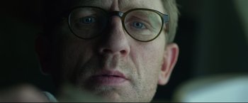 Movie still from “The Girl with the Dragon Tattoo” (2011), directed by David Fincher – A person wearing glasses; Extreme Close Up shot, Low angle