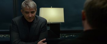 Movie still from “The Girl with the Dragon Tattoo” (2011), directed by David Fincher – A man sitting in front of a lamp in a dark room; Close Up shot, Over the shoulder angle