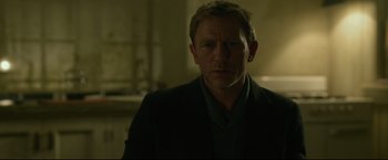 Movie still from “The Girl with the Dragon Tattoo” (2011), directed by David Fincher – A person wearing a suit and tie; Close Up shot, Over the shoulder angle