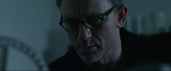 Movie still from “The Girl with the Dragon Tattoo” (2011), directed by David Fincher – A person wearing glasses; Close Up shot, Over the shoulder angle
