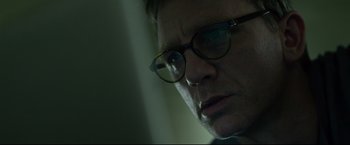 Movie still from “The Girl with the Dragon Tattoo” (2011), directed by David Fincher – A person wearing glasses; Close Up shot, Low angle
