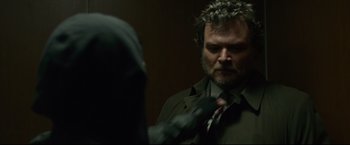 Movie still from “The Girl with the Dragon Tattoo” (2011), directed by David Fincher – A man with a beard is looking at himself in the mirror; Close Up shot, Over the shoulder angle