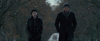 Movie still from “The Girl with the Dragon Tattoo” (2011), directed by David Fincher – A man and a woman standing next to each other; Medium shot, Low angle