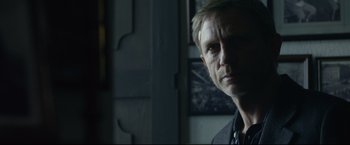 Movie still from “The Girl with the Dragon Tattoo” (2011), directed by David Fincher – A person in a dark room; Close Up shot, Over the shoulder angle